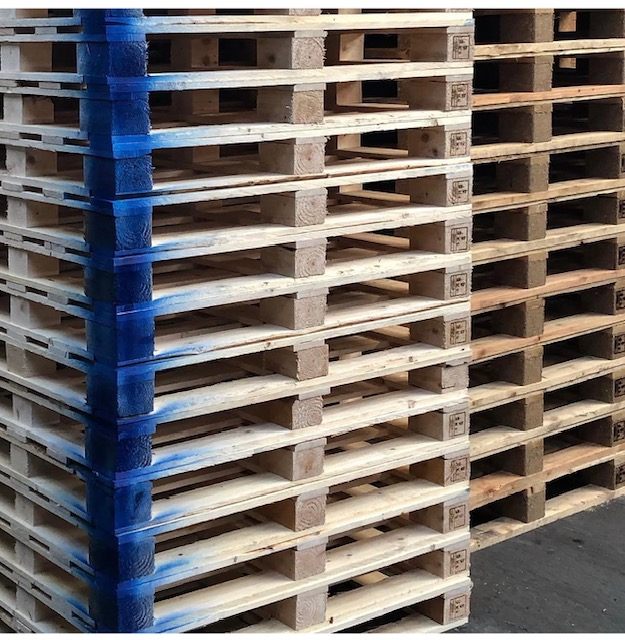Stacks of wooden pallets with blue painted edges